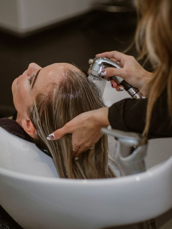 A stylist cutting a client’s hair